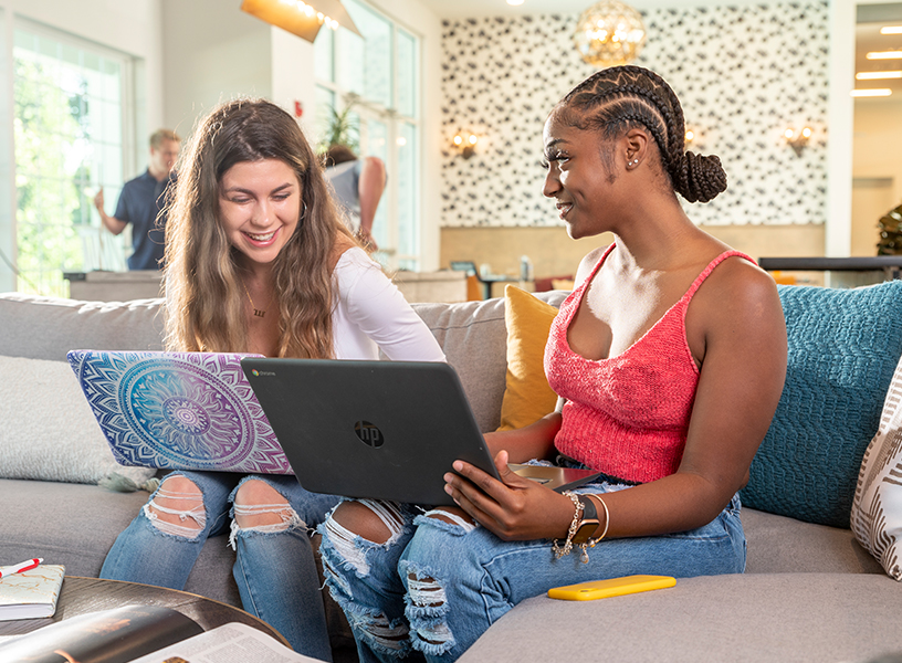 Two young adults with their laptops